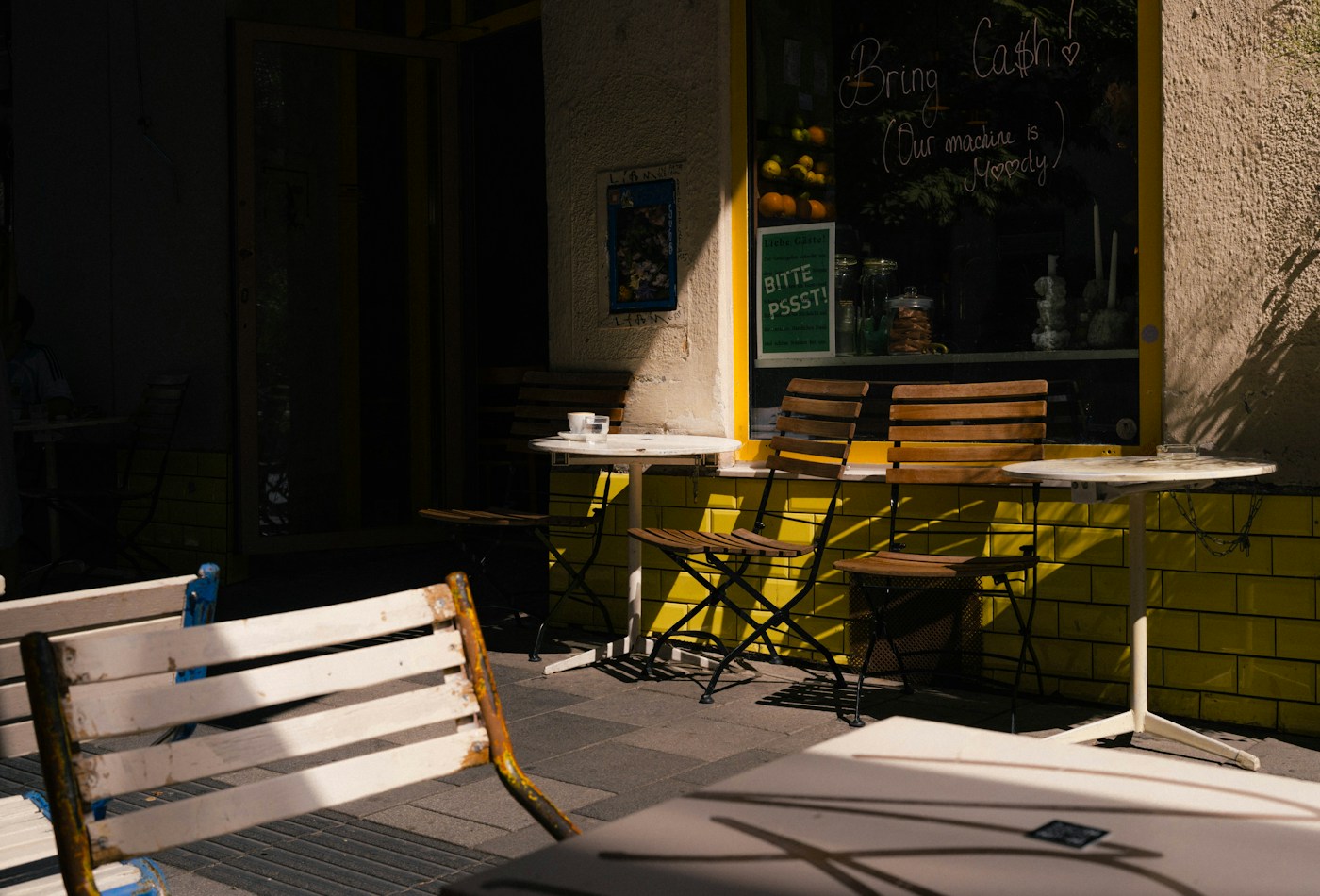 Sunlight falling across outdoor café tables — illustrative stock image