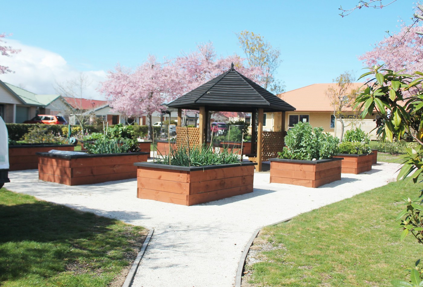 Raised garden beds around a gazebo — illustrative stock image